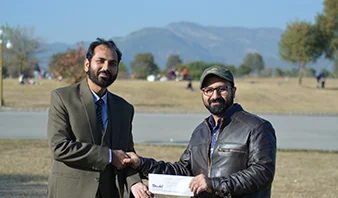Mr. Atta Ur Rehman giving cash prize to Winner Of Bowling Competition Mr. Abdul Basit